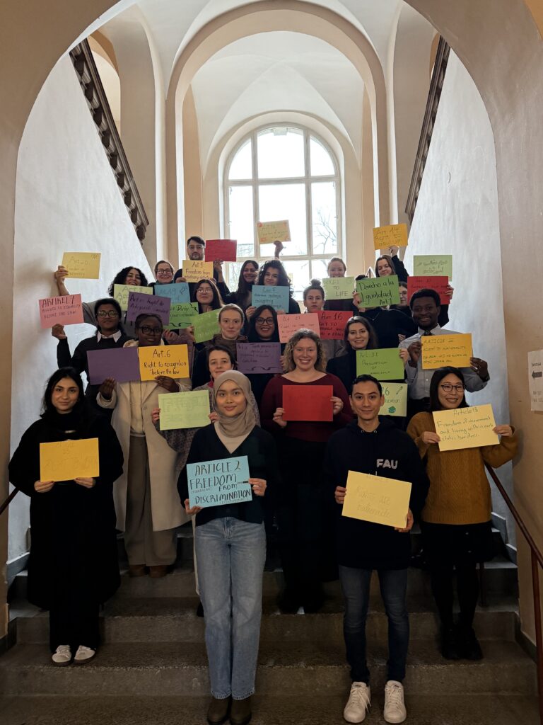 students with colourful signs with articles of the UDHR